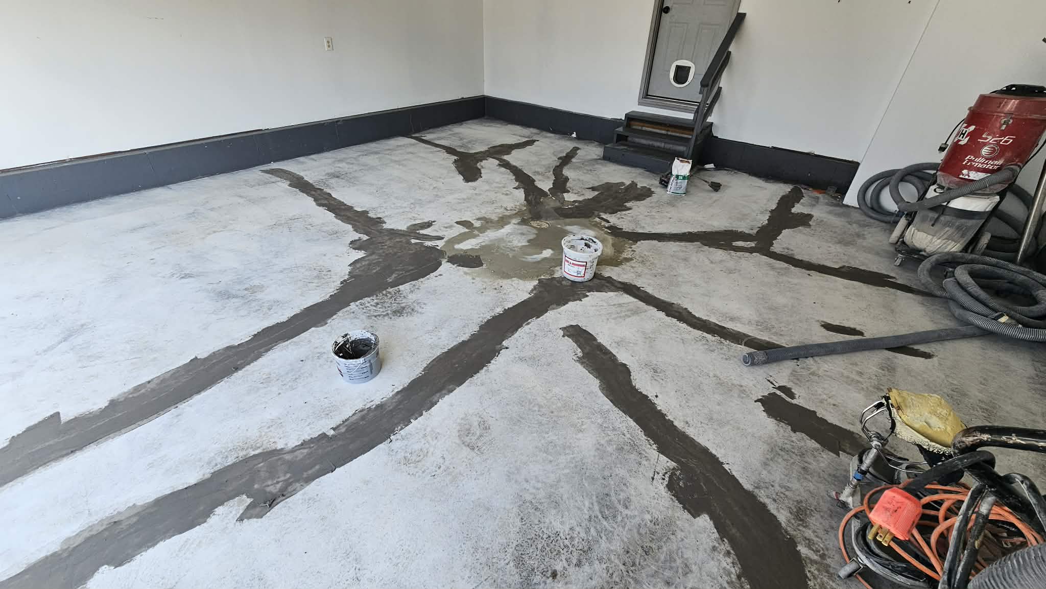 Cracks radiating from a garage floor drain in Liberty MO chased and filled with structural repair material