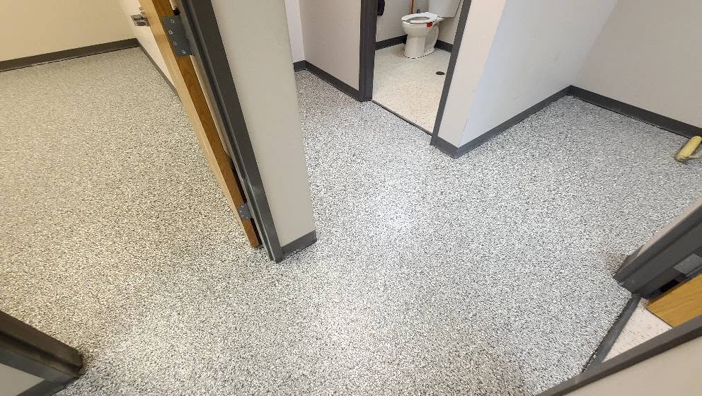Flake epoxy flooring carried through restrooms and corridors at a Lenexa KS commercial branch