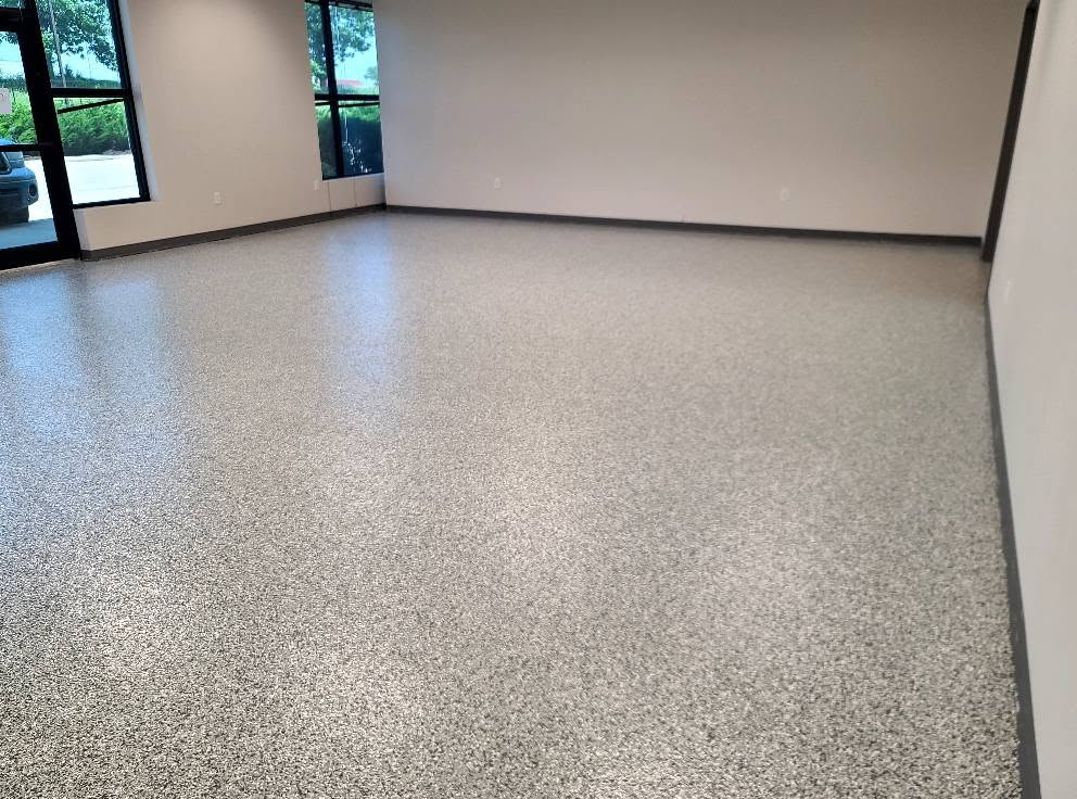 Commercial flake epoxy floor beside storefront glazing at Butler Supply Lenexa KS