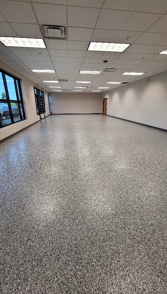 Finished 1/4-inch flake epoxy floor across the main sales floor at Butler Supply in Lenexa, KS