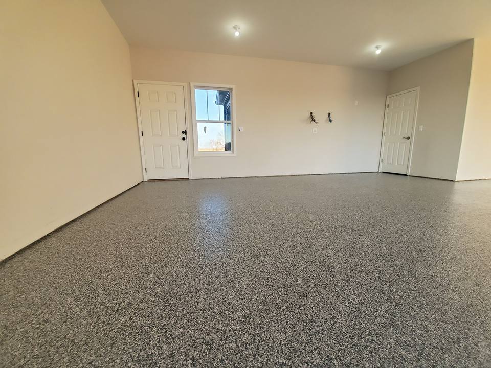 Finished flake epoxy garage floor in Kansas City MO in a tan and brown blend